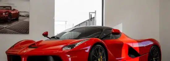 red ferrari 458 italia parked in front of white wall