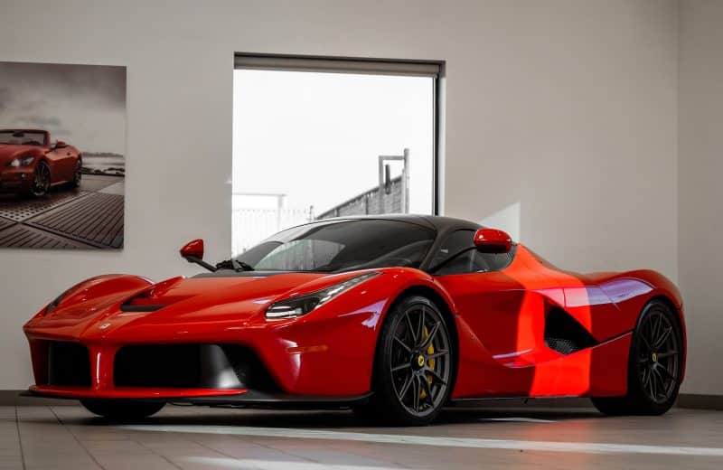 red ferrari 458 italia parked in front of white wall